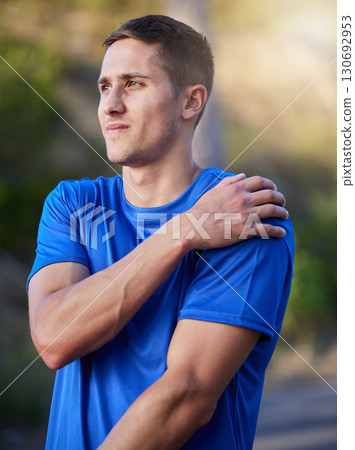 Injury, sport and man holding an arm with pain during running, exercise and strain from cardio. Health, accident and athlete runner with an injured muscle, painful body and inflammation in nature 130692953