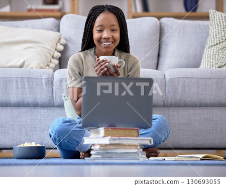 Coffee, student and laptop for girl in living room, happy and relax while streaming in her home. Tea, books and break in distance learning, remote or homeschool for teenage female with online class 130693055