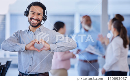 Call center, heart hands and portrait of customer service agent with headset, mockup and smile on face in office. Smiling business man, help desk consultant with care and confidence at crm agency job 130693087