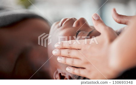 Spa, face massage and black woman luxury for skincare wellness, peace and calm in beauty treatment. Facial therapist and hands for person zen, client healing and stress relief while relax or sleeping 130693348