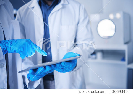 Tablet, research and hands with a team working on science in a lab together for innovation or growth. Doctor, teamwork or medical with a black man and woman scientist at work in a laboratory Tablet, research and hands with a team working on science in a lab together for innovation or growth. Doctor, teamwork or medical with a black man and woman scientist at work in a laboratory 130693401