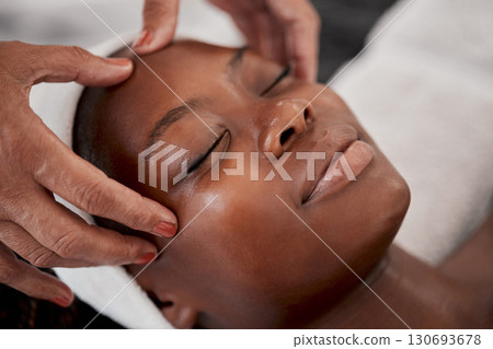 Black woman, relax face and luxury spa massage of a young female ready for facial. Skincare, beauty and wellness clinic with client feeling calm and zen from cosmetic chemical peel treatment Black woman, relax face and luxury spa massage of a young female ready for facial. Skincare, beauty and wellness clinic with client feeling calm and zen from cosmetic chemical peel treatment 130693678