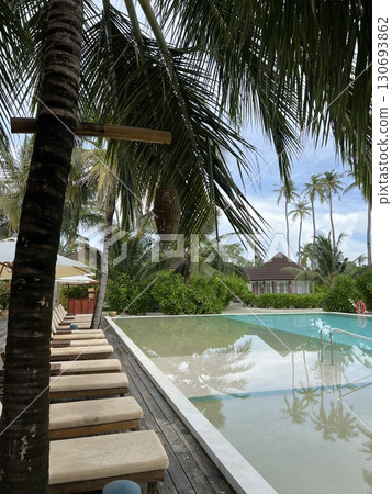 Maldives Paradise: Infinity Pool Overlooking Ocean and Beach 130693862