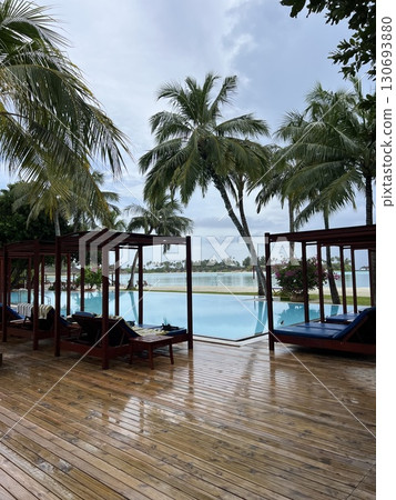 Maldives Paradise: Infinity Pool Overlooking Ocean and Beach 130693880