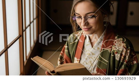 A foreign woman wearing a kimono and glasses enjoying reading in a Japanese-style room 130693929