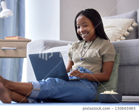 Relax, black woman on floor and laptop for movies, happiness and girl in living room. African American female, lady and device for streaming shows, funny videos or search internet in lounge on ground Relax, black woman on floor and laptop for movies, happiness and girl in living room. African American female, lady and device for streaming shows, funny videos or search internet in lounge on ground 130693965