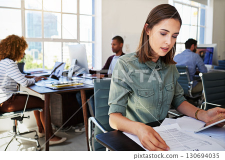 Tablet, documents and planning with a business woman in the office, sitting at her desk for the start of a project. Contract, internet and reading with a creative female employee working on a plan 130694035