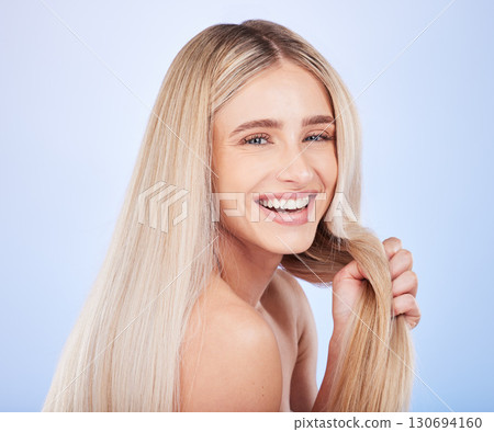 Portrait face, hair care and beauty of woman in studio isolated on a blue background. Cosmetics, laughing and happy young female model with salon treatment for hairstyle, blonde balayage and growth. Portrait face, hair care and beauty of woman in studio isolated on a blue background. Cosmetics, laughing and happy young female model with salon treatment for hairstyle, blonde balayage and growth. 130694160