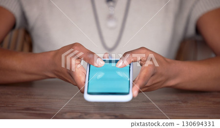 Black woman, hands and phone with green screen or mockup for social media, communication or mobile app. Hand of African American female browsing, typing or texting in networking on smartphone display Black woman, hands and phone with green screen or mockup for social media, communication or mobile app. Hand of African American female browsing, typing or texting in networking on smartphone display 130694331