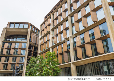 Low angle view of sustainable city architecture with patterned windows and geometry 130694367