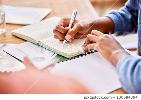 Meeting, discussion and team planning a project while writing creative notes in the office. Collaboration, teamwork and people brainstorming with notebooks while working on report in the workplace. 130694394