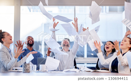 Documents, winner and success with a business team throwing paper into air during a boardroom meeting. Teamwork, wow and a group of people in celebration of a target or goal together in the office Documents, winner and success with a business team throwing paper into air during a boardroom meeting. Teamwork, wow and a group of people in celebration of a target or goal together in the office 130694411