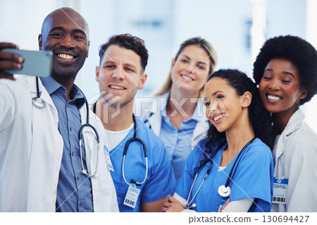 Healthcare, selfie and team of doctors at hospital, happy and proud, smile and bond on blurred background. Medical, diversity and group pose for photo, profile picture or website homepage update Healthcare, selfie and team of doctors at hospital, happy and proud, smile and bond on blurred background. Medical, diversity and group pose for photo, profile picture or website homepage update 130694427