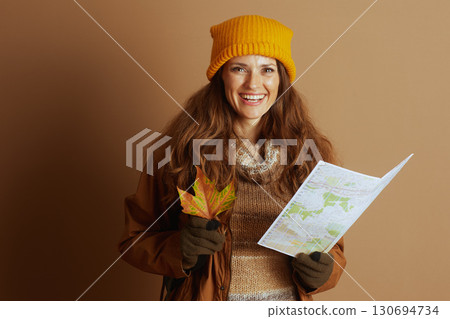 Autumn Traveler with Folded Map and Leaf 130694734