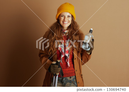 Woman Hiker in Orange Sweater and Yellow Hat 130694740