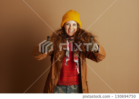 Joyful Woman in Yellow Beanie Shows Approval Joyful Woman in Yellow Beanie Shows Approval 130694750