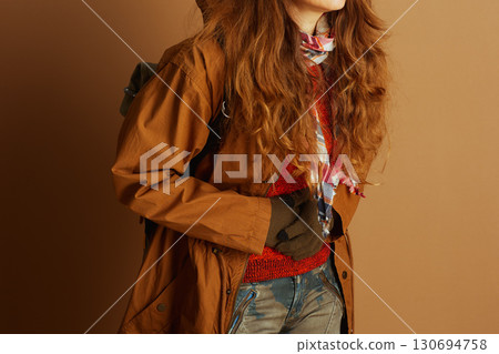 Woman in Layered Autumn Outfit, Hands Clasped 130694758