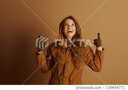 Excited Woman Pointing Up and Laughing Excited Woman Pointing Up and Laughing 130694771