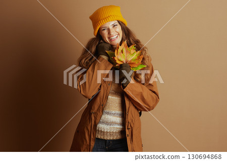 Woman Holding Autumn Leaves in Warm Gear 130694868