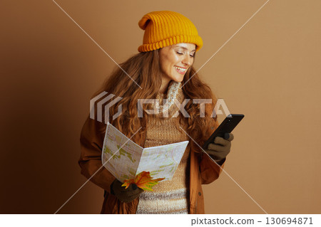 Focused Traveler Planning Route with Map and Phone 130694871