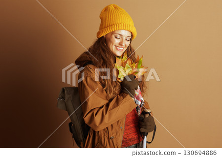 Smiling Hiker with Autumn Leaves and Hooded Jacket Smiling Hiker with Autumn Leaves and Hooded Jacket 130694886