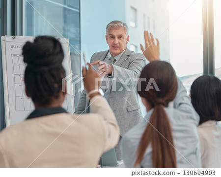 Senior businessman, coaching and presentation with question in team collaboration or engagement at office. Elderly male CEO leader or coach training staff with hands raised in FAQ, teamwork or answer 130694903