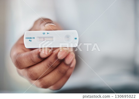 Rapid exam and black man hand with covid test for quick viral detection and healthcare check. Corona virus pcr and results of person with medical kit at hospital or virus testing clinic zoom. 130695022