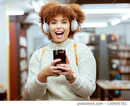 University student, woman and phone for texting, library and headphones for streaming music, happy and online. Gen z girl, smartphone and social media app for chat communication on internet at campus University student, woman and phone for texting, library and headphones for streaming music, happy and online. Gen z girl, smartphone and social media app for chat communication on internet at campus 130695381