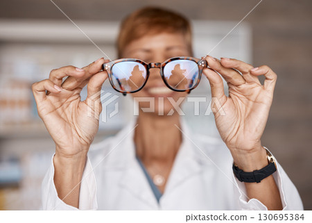 Optometry, hands and doctor with glasses in hospital or clinic for ophthalmology. Vision, healthcare and happy woman or medical optician with spectacles, frames or lenses for eye care and wellness 130695384