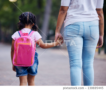 Holding hands, mom and child walking to school, help and care with support outdoor, education and growth. Kindergarten, development in childhood and backpack, family, woman with girl in the morning Holding hands, mom and child walking to school, help and care with support outdoor, education and growth. Kindergarten, development in childhood and backpack, family, woman with girl in the morning 130695445