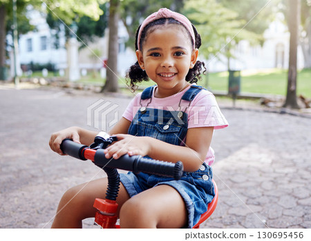 Portrait, young girl on bike in park and happy child outdoor with nature and freedom, smile while riding. Travel, happiness and adventure, growth and childhood with family day out and cycling mockup Portrait, young girl on bike in park and happy child outdoor with nature and freedom, smile while riding. Travel, happiness and adventure, growth and childhood with family day out and cycling mockup 130695456
