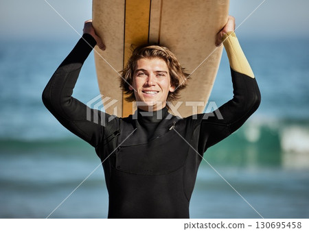 Fitness, beach and portrait of a surfer with a surfboard for exercise, fun and adventure on vacation. Water sports, travel and man athlete surfing by the ocean on a tropical holiday in Australia. Fitness, beach and portrait of a surfer with a surfboard for exercise, fun and adventure on vacation. Water sports, travel and man athlete surfing by the ocean on a tropical holiday in Australia. 130695458
