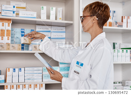 Pharmacy woman, tablet and medicine shelf to check inventory and product information search. Pharmacist person with Pharma app in clinic or shop for pharmaceutical, medical and health search or order 130695472