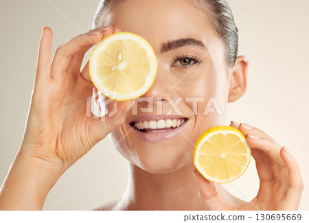 Beauty, face portrait and happy woman with lemon for natural fruit detox, health wellness or facial skincare glow. Spa salon, dermatology healthcare and nutritionist model with vitamin c food product Beauty, face portrait and happy woman with lemon for natural fruit detox, health wellness or facial skincare glow. Spa salon, dermatology healthcare and nutritionist model with vitamin c food product 130695669