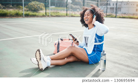 Sports music, phone and netball woman listening to mp3 radio, audio podcast or playlist song after training practice. Relax wellness, digital headphones and African athlete streaming sound on court Sports music, phone and netball woman listening to mp3 radio, audio podcast or playlist song after training practice. Relax wellness, digital headphones and African athlete streaming sound on court 130695694