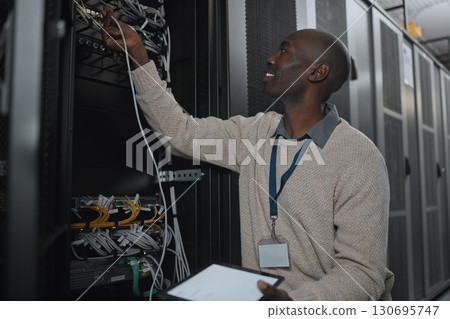 Engineer, server room and black man with cable and tablet for database maintenance or software update. Cybersecurity, it or startup male coder on tech for programming or networking in data center Engineer, server room and black man with cable and tablet for database maintenance or software update. Cybersecurity, it or startup male coder on tech for programming or networking in data center 130695747