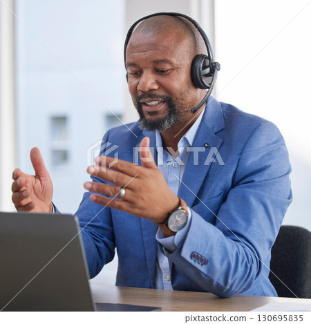 Black man, laptop and video call consulting with headset at office desk for telemarketing, customer service or support. African man working on computer explaining business proposal in call center 130695835