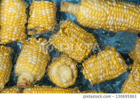 Fresh Corn Cobs Splashing in Water Top View. Fresh Corn Cobs Splashing in Water Top View. 130695861