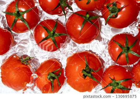 Top View of Wet Tomatoes in Fresh Splash Scene 130695875