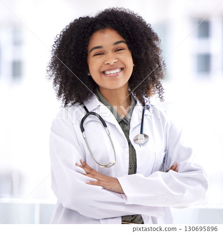 Doctor, black woman and smile portrait for healthcare with life insurance in hospital for wellness. Face of happy medical professional with arms crossed with pride for career, motivation and medicine Doctor, black woman and smile portrait for healthcare with life insurance in hospital for wellness. Face of happy medical professional with arms crossed with pride for career, motivation and medicine 130695896