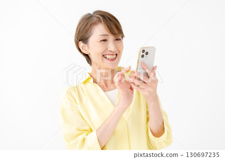 A woman operating a smartphone with a smile 130697235