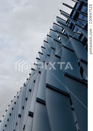 Waves on the glass facade of a building Waves on the glass facade of a building 130697528