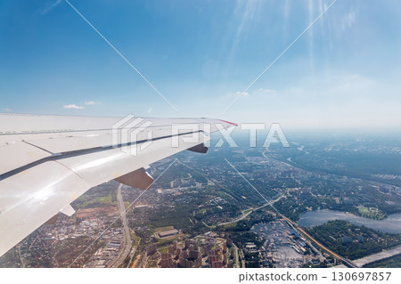 View from the airplane window during taking off on a clear summer morning View from the airplane window during taking off on a clear summer morning 130697857