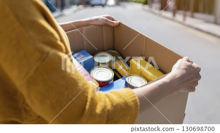 Hands holding donation box charity help community food volunteer support 130698700