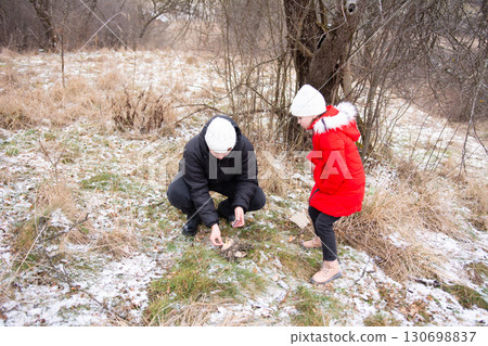 Exploring nature on a chilly winter day with family while discovering unique treasures in the snowy grasslands Exploring nature on a chilly winter day with family while discovering unique treasures in the snowy grasslands 130698837