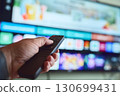 Relaxing at home, watching TV 130699431