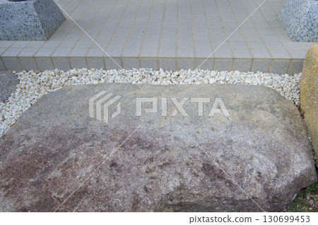 Paving stones and pebbles in front of the entrance 130699453