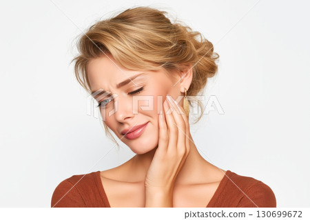 sad young woman holds sore cheek on white isolated background. Severe ache toothache. Problems and pain in teeth and gums. Dentistry and dental clinic sad young woman holds sore cheek on white isolated background. Severe ache toothache. Problems and pain in teeth and gums. Dentistry and dental clinic 130699672