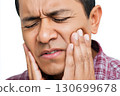 sad adult arab male holds sore cheek on white isolated background. Severe ache toothache. Problems and pain in teeth and gums. Dentistry and dental clinic 130699678