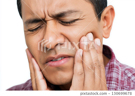 sad adult arab male holds sore cheek on white isolated background. Severe ache toothache. Problems and pain in teeth and gums. Dentistry and dental clinic 130699678